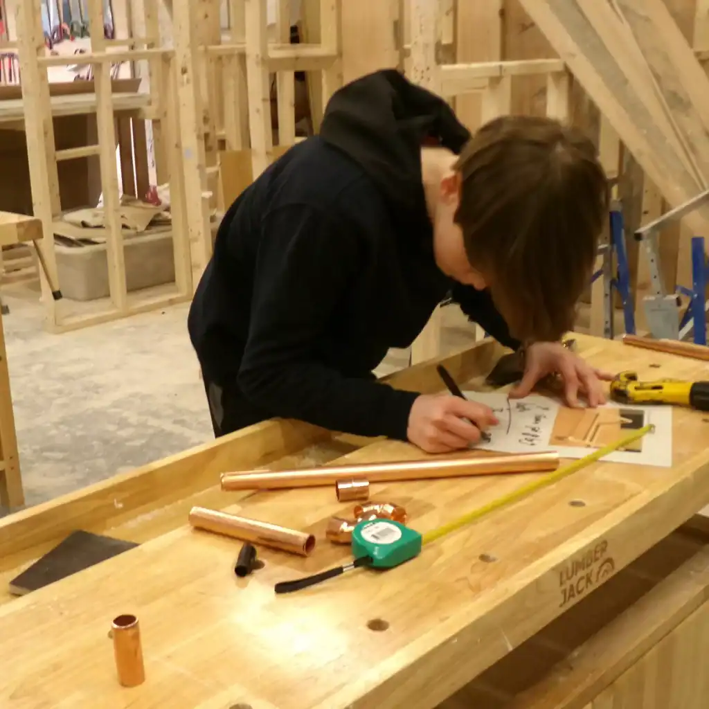 Image of a student working in a construction class.